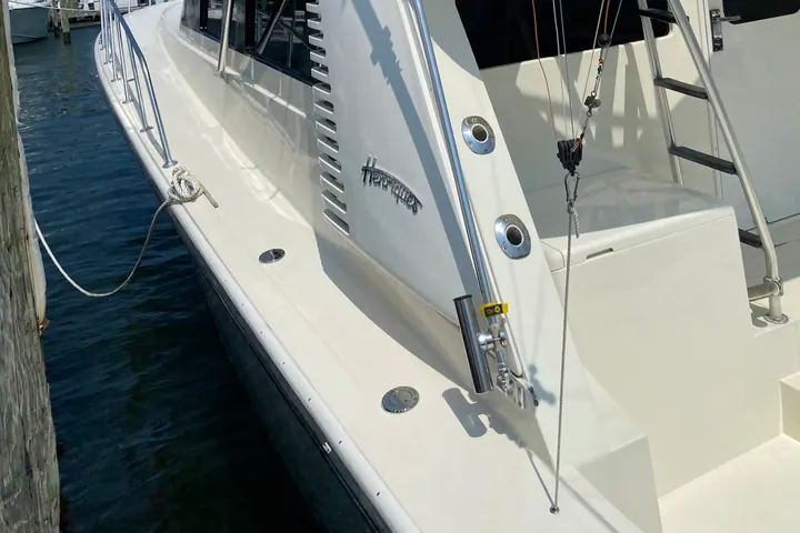 The cockpit and transom of a detailed sport fishing boat seen from the dock, non-skid scrubbed and gelcoat gleaming
