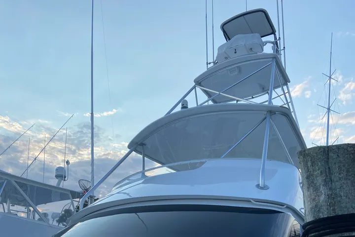 The flybridge and hardtop of a convertible sport fisherman against an evening sky, freshly washed and waxed