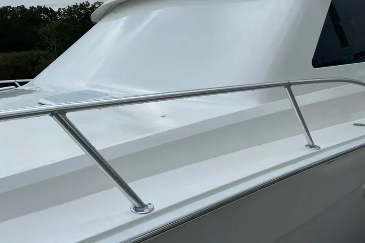 Close detail of a sport fisherman's polished white superstructure and stainless rail, gelcoat corrected and sealed